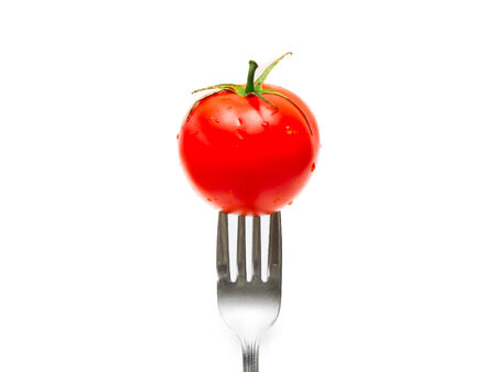 tomato and fork isolated on white backgroundの写真素材