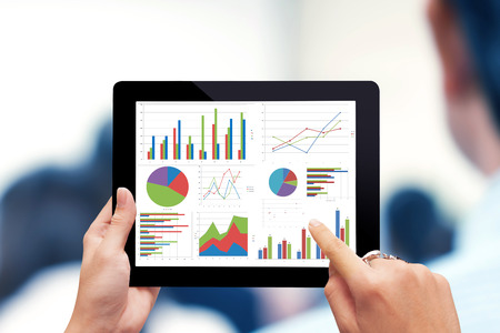 Close-up of male hands touching  tablet with business diagramの写真素材