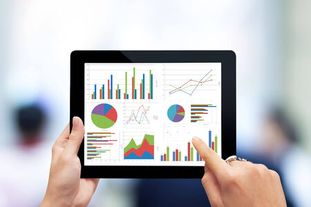 Close-up of male hands touching  tablet with business diagramの写真素材