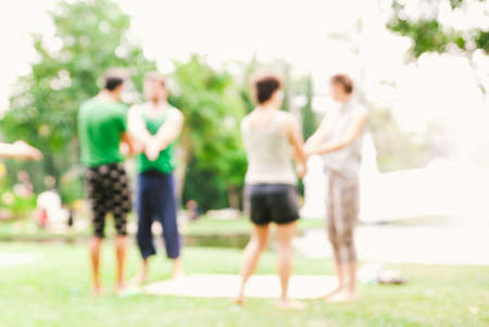 blurred young happy people excercis in the park