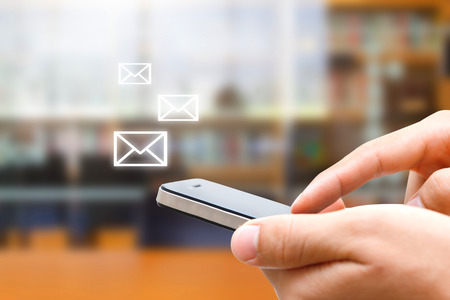 closeup of man hand using smartphone in officeの写真素材