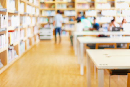 Blurred background of modern library with people and bookshelvesの写真素材