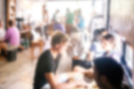 blurred background of talking people in coffee cafeの写真素材