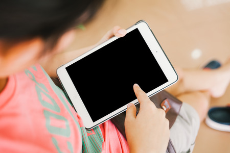 young woman use blank digital tablet, sitting poseの写真素材