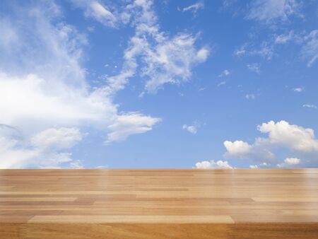Empty wooden table with blue sky and cloud, product displayの写真素材