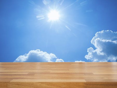 Empty wooden table with blue sky and cloud, product displayの写真素材