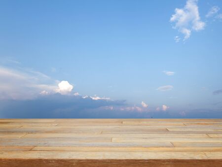 Empty wooden table with blue sky and cloud, product displayの写真素材