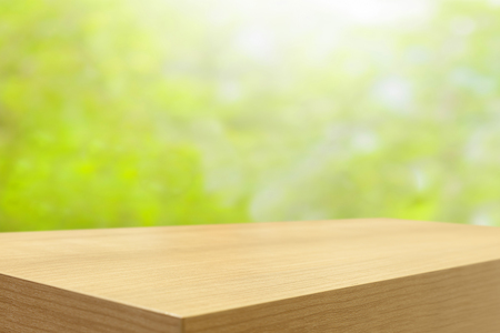 Empty wooden table and green natural spring blur bokeh background , product display montageの写真素材