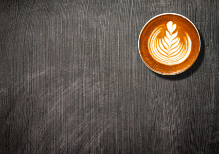 Coffee cup top view on black borad table background with copy spaceの写真素材