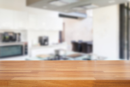 Empty wooden table and blurred kitchen background, product  montage displayの写真素材