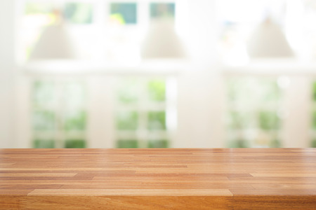 Empty wooden table and modern  background with green ourdoor view against window and lamp, Ready for product montageの写真素材