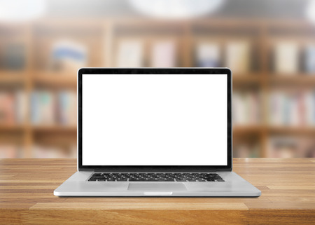 Laptop with blank screen on table. interior background, bookshelf, library の写真素材