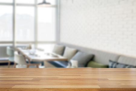 Empty wooden table and blurred modern white kitchen coffee cafe background, restaurants. Ready for product montage, bokeh , lightの写真素材