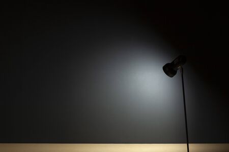 Background with lamps on a desk and a black wallの写真素材