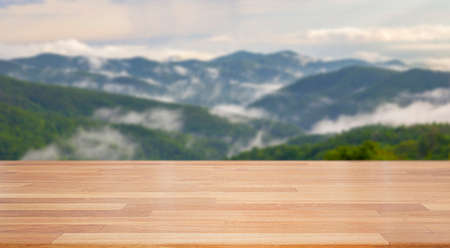 beautiful empty wood table with blur nature mountain with cloud background. Ready for product display  montageの写真素材