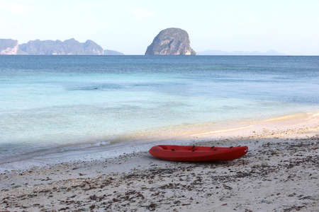 red mini boat on the beachの写真素材