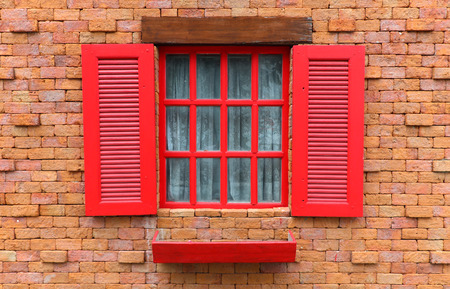 Red wood windows on brick wall texture background, Vintage style