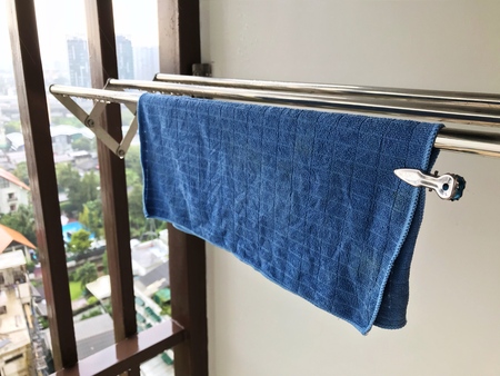 Blue cloth wipes on stainless steel extendable clothes linesの写真素材