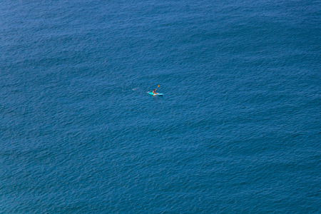 Men paddle kayak on the sea in daytime at Phuket province, Thailandの写真素材