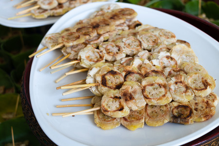 Grilled bananas on white plate, Thai dessertの写真素材