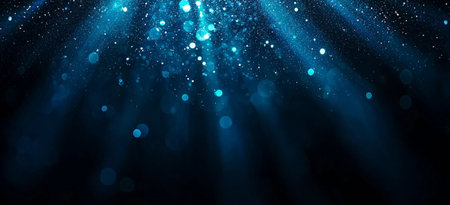 A Stunning blue gradient background with light beams and sparkling particles creates serene underwater atmosphere. Perfect for various design projectsの素材