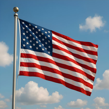 Flag of United States of America waving in the wind against blue skyの素材