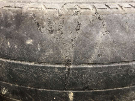old tire damaged and dirty on surface close upの写真素材