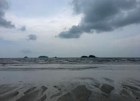 tranquil beach with find sand in rainy season. soft focus of dark mode for seaの写真素材