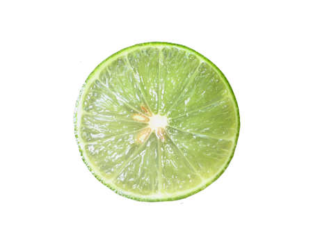Juicy lime slice circle shape isolated on white backgroundの写真素材