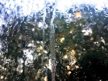 Window glass with condensation selective focus. High humidity in the morning in winter season. ...