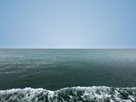 Beautiful calm sea wave under clear sky background