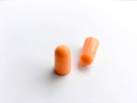 Orange ear plugs alignment isolated on white backgroundの写真素材