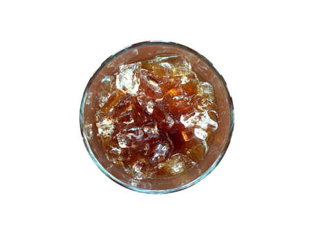 Ice black coffee in transparent glass isolated on white background. Top view image with light reflection.の写真素材