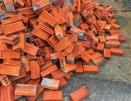 fresh red brick pile on the ground at construction area