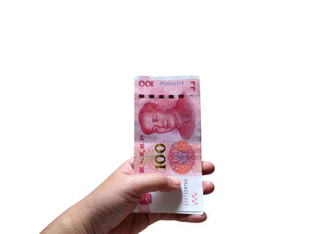 Woman hand holding one hundred Chinese yuan money stacking isolated on white background. Chinese...