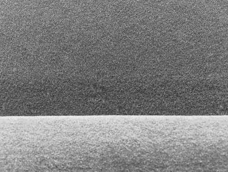 Dark grey felt fabric texture with light gray edge background. Pool and snooker table surface.