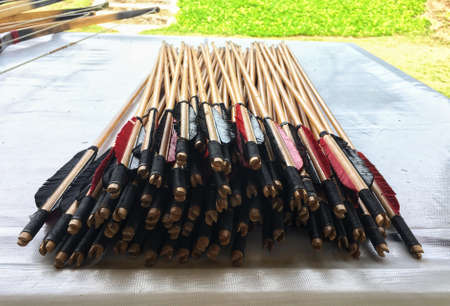 Group of wooden arrow wing for archery on white table at archery field.