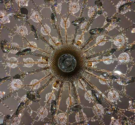 Bottom view of crystal chandelier lamp hang on white ceiling. Luxury lighting lamp design.の写真素材