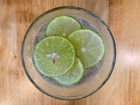 Juicy lime slice circle shape stacking on top of soda in the glass. Freshness and cool ingredient