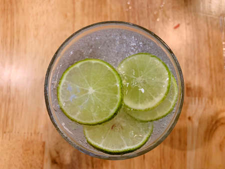 Juicy lime slice circle shape stacking on top of soda in the glass. Freshness and cool ingredientの写真素材
