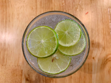Juicy lime slice circle shape stacking on top of soda in the glass. Freshness and cool ingredientの写真素材