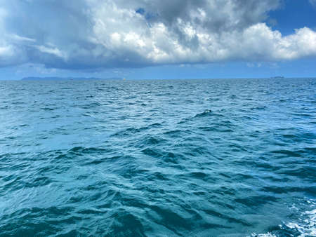 Beautiful calm sea wave under clear blue sky backgroundの写真素材