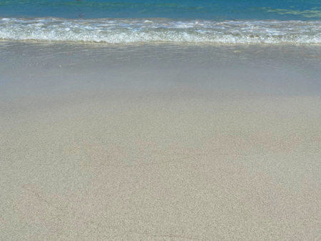 Beautiful calm blue sea and ripple on white sand at the beachの写真素材