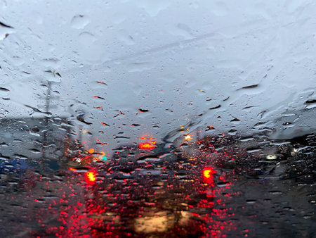 Soft focus of raindrop on window glass with blurred of car on the road when traffic jam in the rainy season.の写真素材