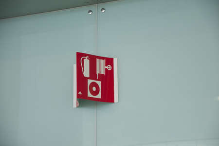 information sign with fire extinguisher, hose and alarm