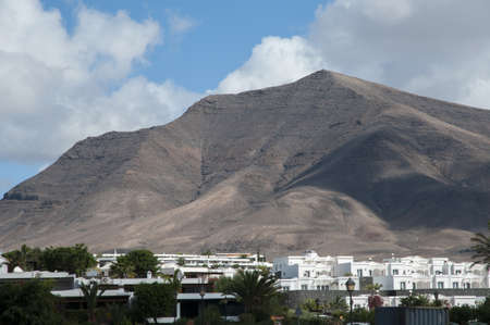 huge volcano above the white colored buildingsのeditorial素材
