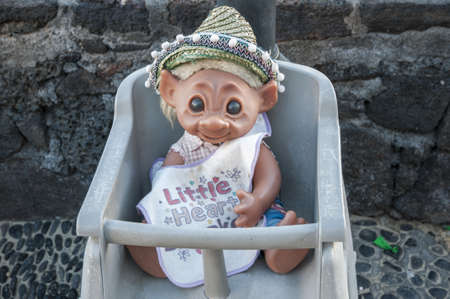 doll sitting in a chair ready to eat toddlerの写真素材