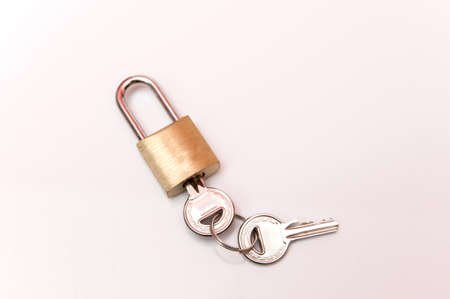 lock with keys to close the bags on a white backgroundの写真素材