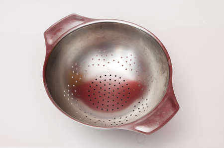 large colander over a white backgroundの写真素材