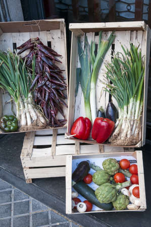 boxes with vegetables with onions, tomatoes, cucumbers and artichokes